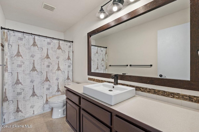 full bathroom featuring decorative backsplash, visible vents, vanity, and toilet