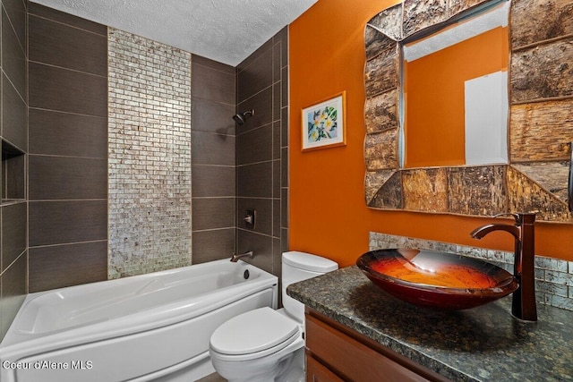 bathroom featuring toilet,  shower combination, a textured ceiling, and vanity