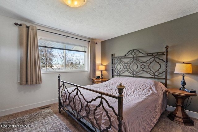 bedroom featuring a textured ceiling, carpet flooring, and visible vents