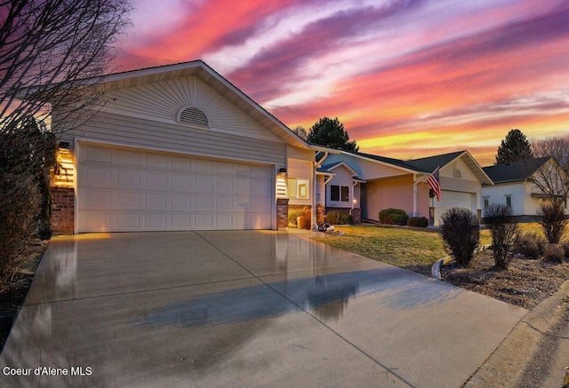 single story home featuring a garage, stone siding, and concrete driveway