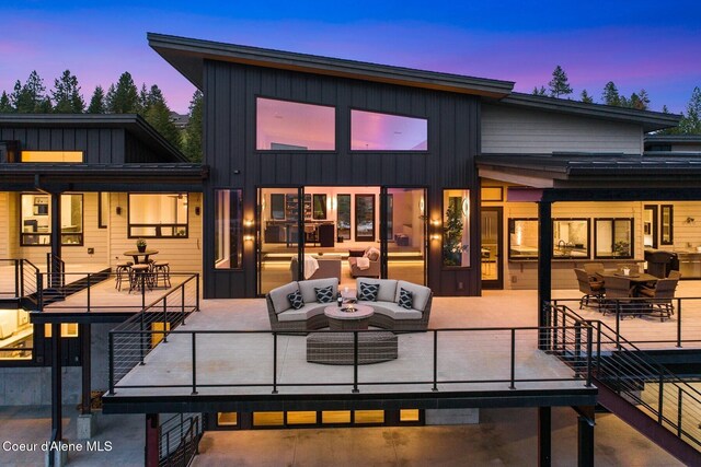 2766 S Helen Dr, Coeur Dalene, ID 83814 - rear view of property featuring board and batten siding, outdoor dining space, a patio area, and outdoor lounge area