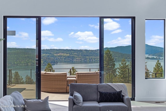 2766 S Helen Dr, Coeur Dalene, ID 83814 - interior space with a water view, wood finished floors, visible vents, baseboards, and a view of trees