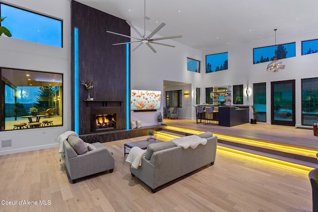 2766 S Helen Dr, Coeur Dalene, ID 83814 - living room with a large fireplace, a high ceiling, wood finished floors, and baseboards