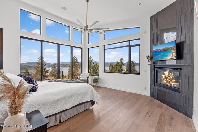 2766 S Helen Dr, Coeur Dalene, ID 83814 - bedroom with a high ceiling, a fireplace, baseboards, and wood finished floors