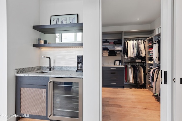 2766 S Helen Dr, Coeur Dalene, ID 83814 - bar with light wood-type flooring, wine cooler, indoor wet bar, and a sink