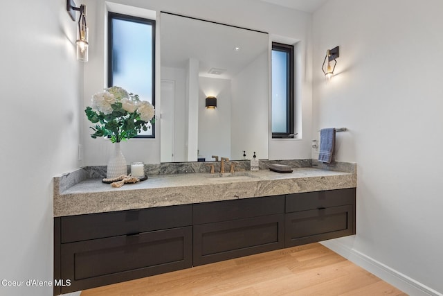2766 S Helen Dr, Coeur Dalene, ID 83814 - bathroom with wood finished floors, vanity, and baseboards