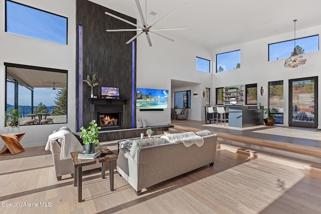 2766 S Helen Dr, Coeur Dalene, ID 83814 - living area with a towering ceiling, a fireplace, and wood finished floors