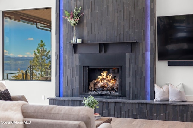 2766 S Helen Dr, Coeur Dalene, ID 83814 - living room with a lit fireplace and wood finished floors
