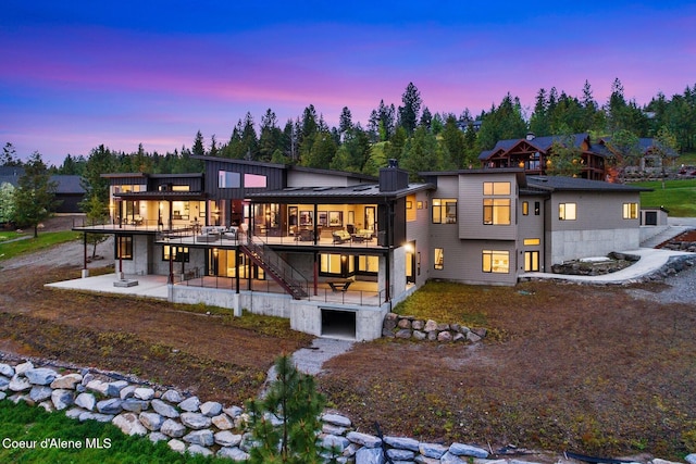 2766 S Helen Dr, Coeur Dalene, ID 83814 - back of house at dusk featuring stairway, a deck, and a patio