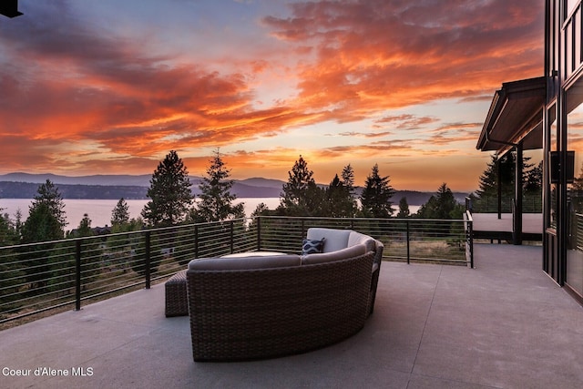 2766 S Helen Dr, Coeur Dalene, ID 83814 - patio terrace at dusk with a balcony, a mountain view, and outdoor lounge area