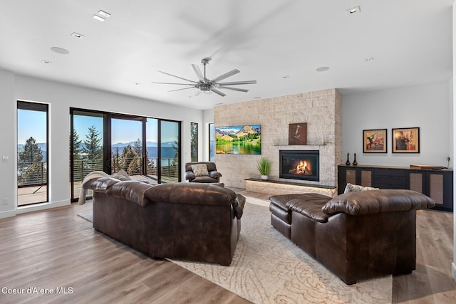 2766 S Helen Dr, Coeur Dalene, ID 83814 - living room featuring ceiling fan, a fireplace, baseboards, and wood finished floors