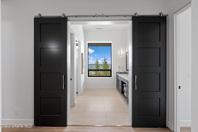2766 S Helen Dr, Coeur Dalene, ID 83814 - interior space with light tile patterned floors, baseboards, and a barn door