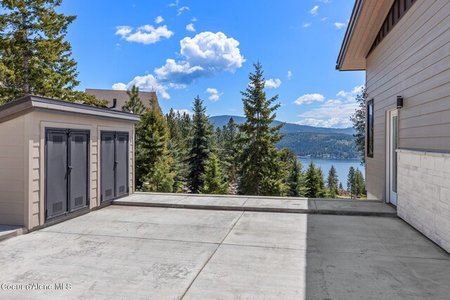 2766 S Helen Dr, Coeur Dalene, ID 83814 - view of patio / terrace with a water and mountain view and an outbuilding