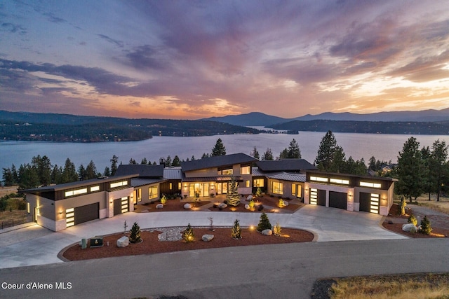 2766 S Helen Dr, Coeur Dalene, ID 83814 - view of front of property with a standing seam roof, curved driveway, an attached garage, and metal roof