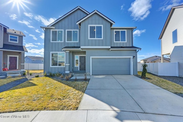 view of front of home with board and batten siding, fence, and driveway