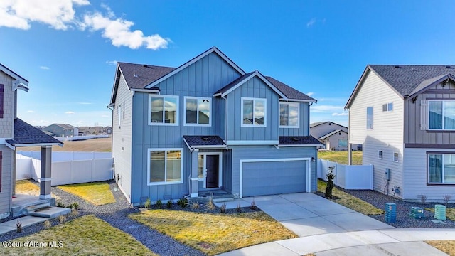 view of front of property featuring board and batten siding, fence, and driveway