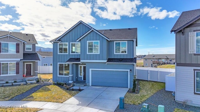 view of front of home featuring a garage, fence, concrete driveway, a gate, and board and batten siding