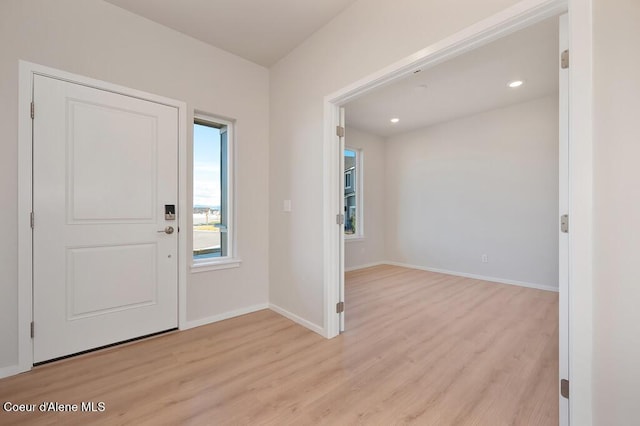 foyer entrance with recessed lighting, light wood-style flooring, and baseboards