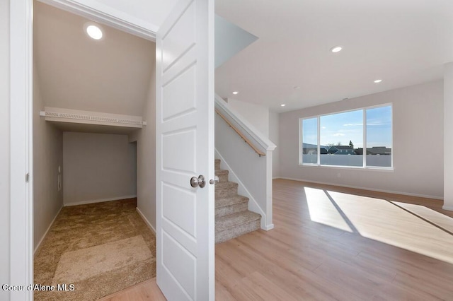 interior space with baseboards, wood finished floors, and recessed lighting