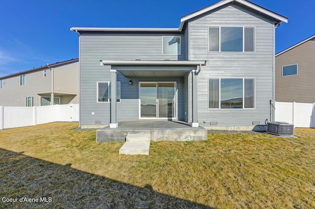 back of property featuring crawl space, a patio, fence, and a lawn