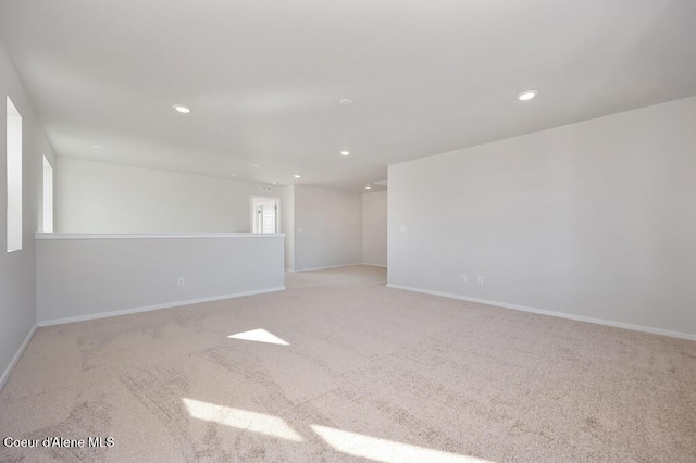 empty room with carpet floors, recessed lighting, and baseboards