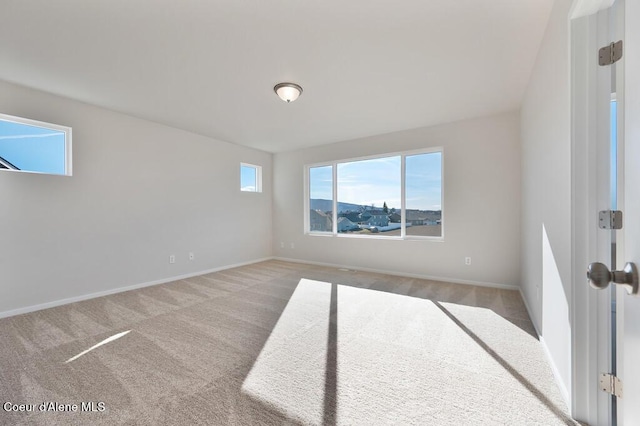 spare room with carpet floors and baseboards