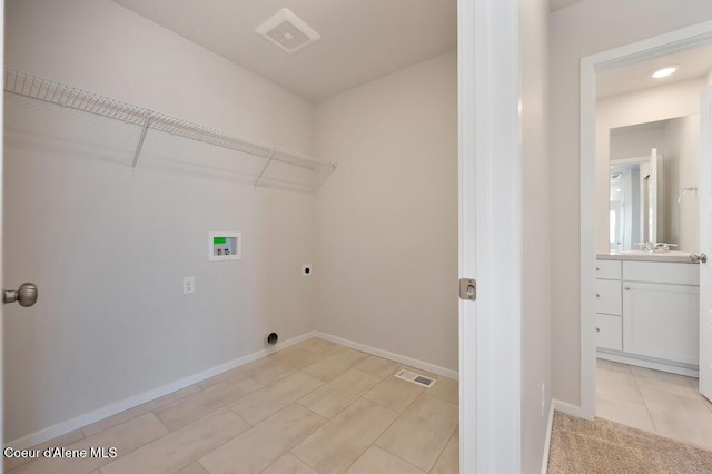 clothes washing area with laundry area, hookup for a washing machine, visible vents, and hookup for an electric dryer