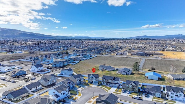 drone / aerial view featuring a residential view and a mountain view