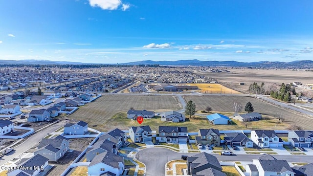 drone / aerial view featuring a residential view and a mountain view