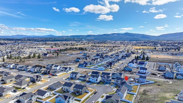 drone / aerial view featuring a residential view and a mountain view