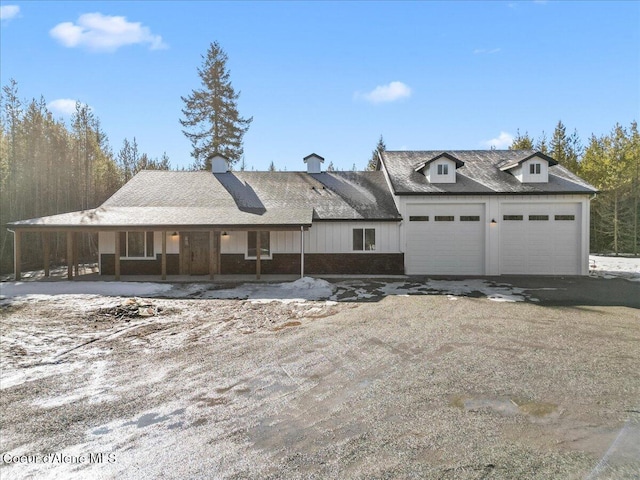 view of front of home featuring a garage, driveway, and solar panels