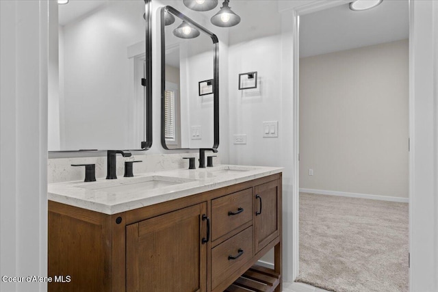 full bathroom featuring double vanity, a sink, and baseboards