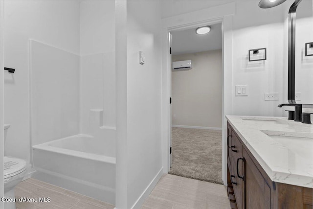 full bathroom featuring an AC wall unit, toilet, baseboards, and vanity