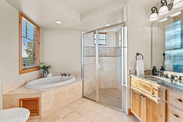 bathroom with a garden tub, a shower stall, and vanity