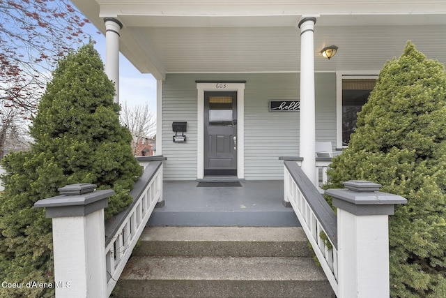 view of exterior entry featuring a porch