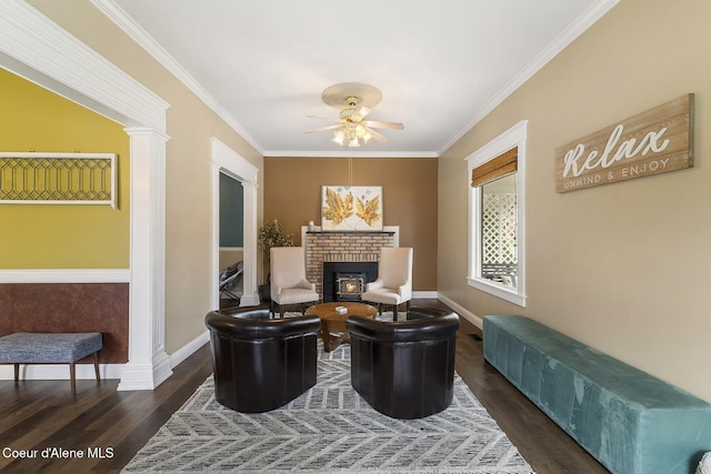 sitting room featuring crown molding, a fireplace, baseboards, and wood finished floors