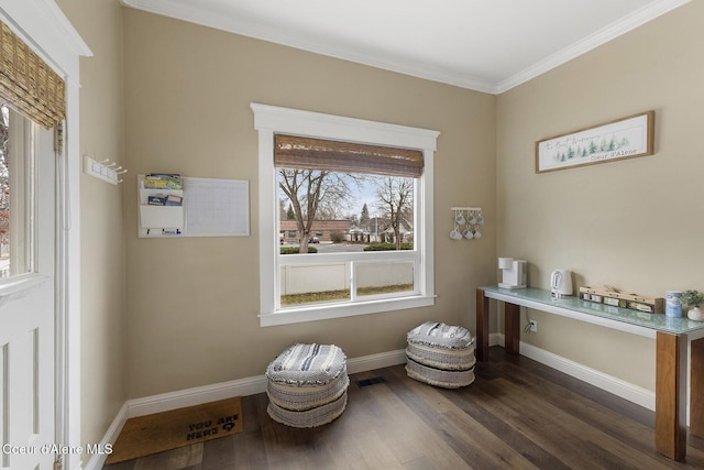 sitting room with crown molding, dark wood finished floors, visible vents, and baseboards