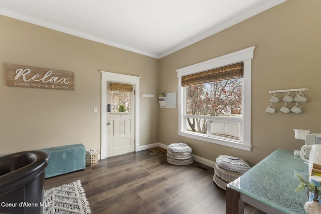 living area featuring baseboards, ornamental molding, and wood finished floors