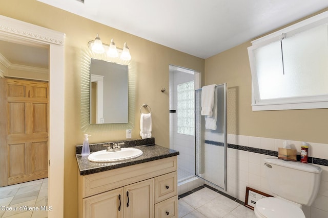 full bath featuring tile patterned flooring, a healthy amount of sunlight, a shower stall, and vanity