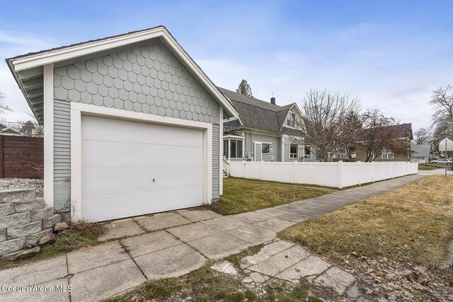 view of front of house with a garage and fence