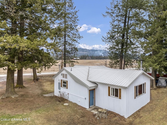 view of front of property featuring a mountain view and metal roof