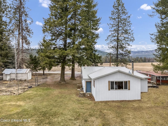 exterior space with a mountain view and an outbuilding