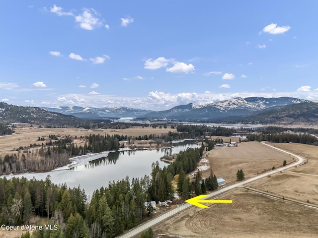 drone / aerial view with a water and mountain view