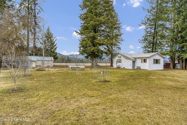 view of yard featuring a mountain view and fence