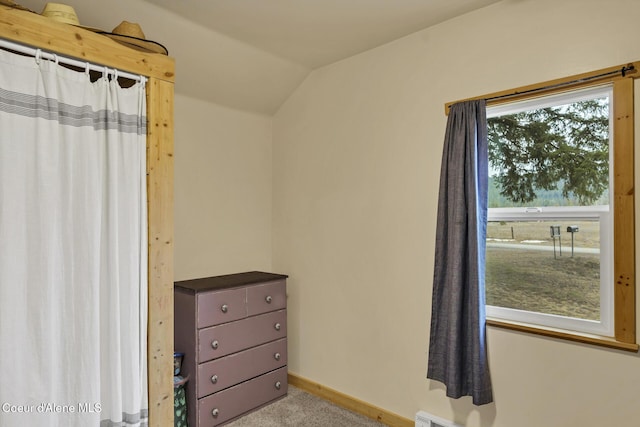 unfurnished bedroom with baseboards, carpet floors, and vaulted ceiling