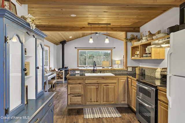 kitchen with tile countertops, double oven range, freestanding refrigerator, a sink, and under cabinet range hood