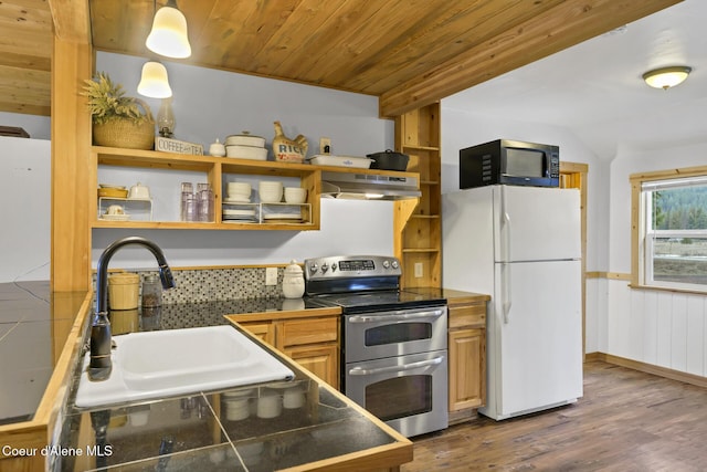 kitchen with a sink, under cabinet range hood, double oven range, freestanding refrigerator, and open shelves