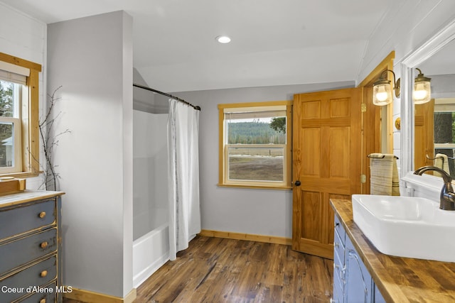 full bathroom featuring wood finished floors, recessed lighting, shower / bath combination with curtain, baseboards, and vanity