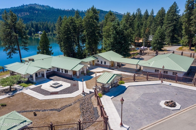 bird's eye view with a water view and a wooded view