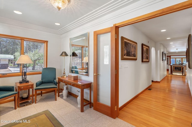 hallway featuring visible vents, baseboards, crown molding, light floors, and recessed lighting